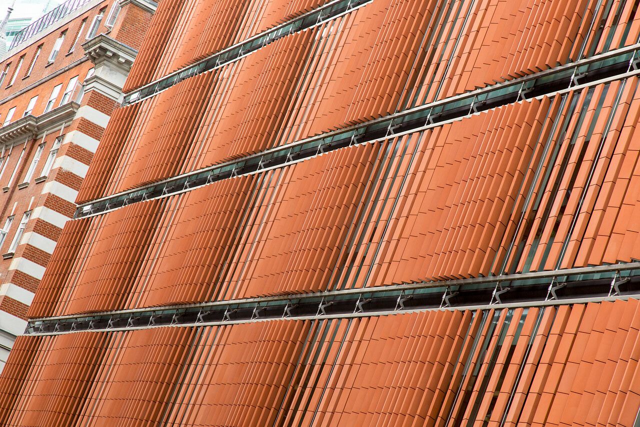The brick-coloured exterior panels of the UCL Cancer Institute, based at the Paul O'Gorman Building in Bloomsbury.