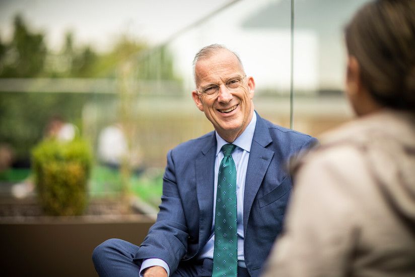 Photograph of Dr Michael Spence, UCL President & Provost, in conversation.